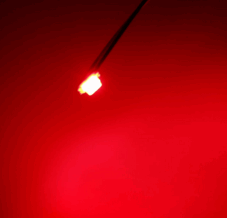 A red light is seen in the dark.