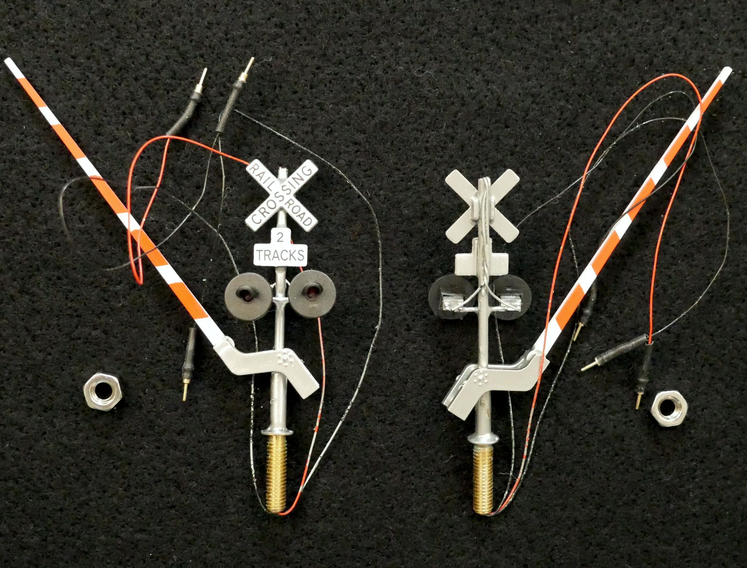 A couple of train signals are connected to wires.