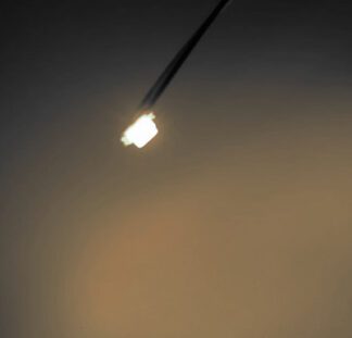 A street light is lit up in the dark.